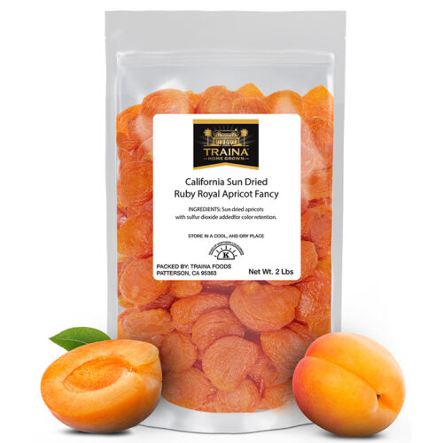 2 lb bag of our California Sun Dried Ruby Royal Apricots, Fancy with two fresh apricots displayed in front to show context.